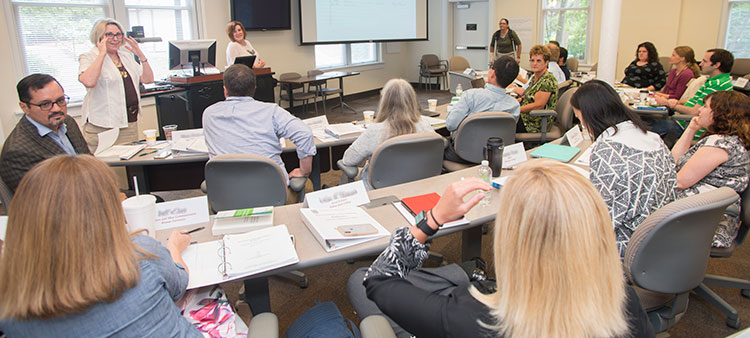 Director Marguerite Koepke and Cynthia Alby (Professor, Georgia College & State University) address the group.